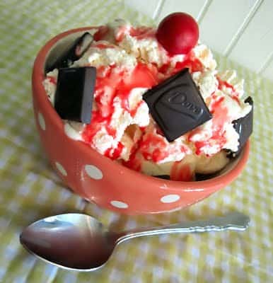 Ice cream sundae with dove chocolates, strawberry syrup, and a fireball candy on top