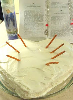 White heart cake with pretzel sticks