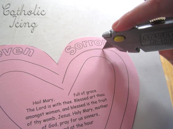 Cutting heart paper with exact-o knife.