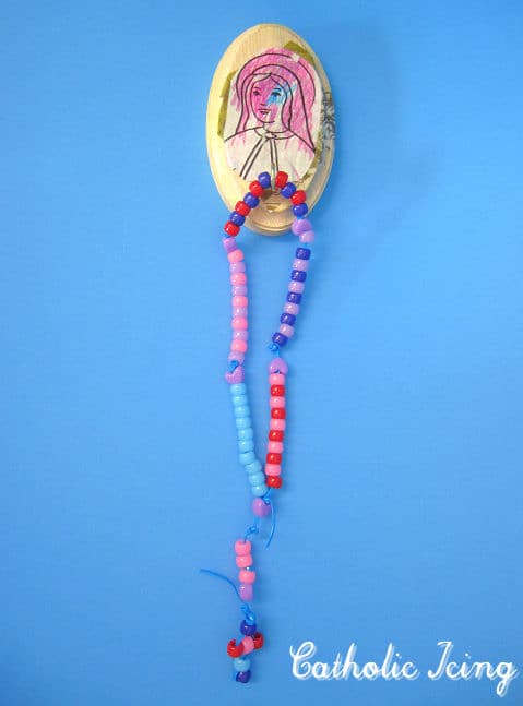 Preschooler rosary craft hanger.