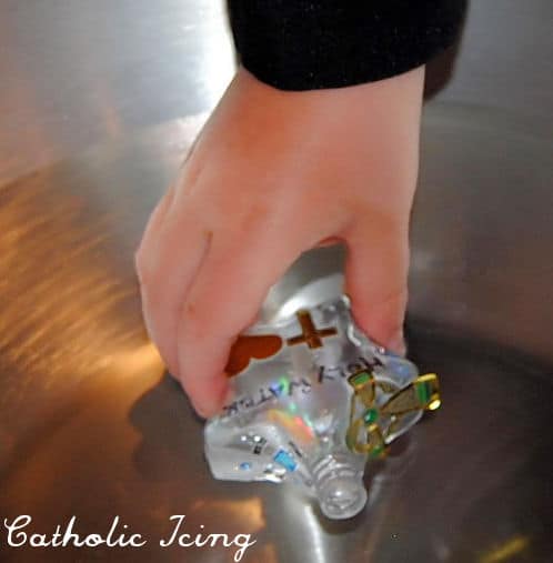 filling holy water bottles with kids